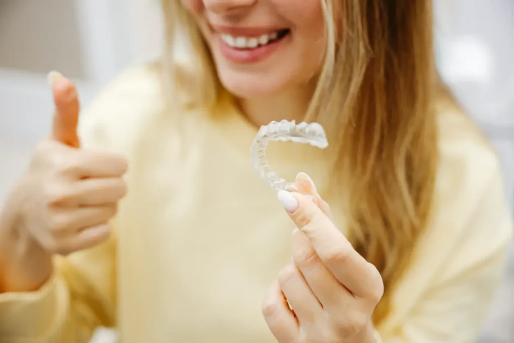 Woman holding clear aligners