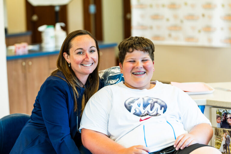 Technician With Smiling Patient